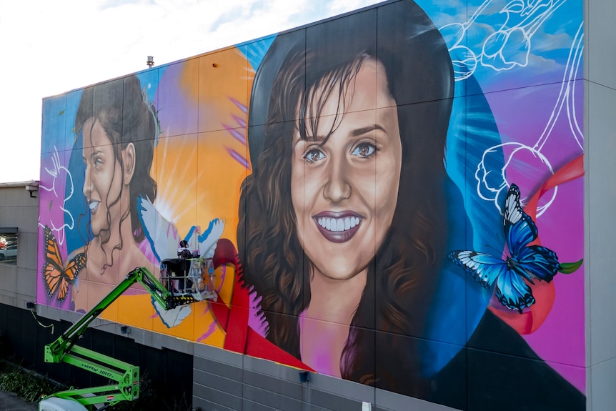 A large, colourful mural with two images of Gordana and butterflies.