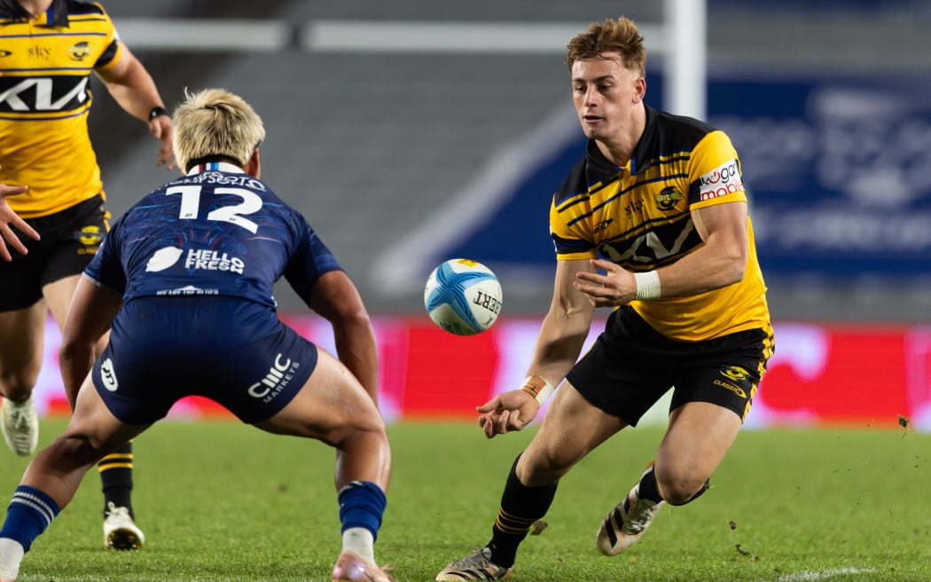 Hurricanes first-five Ruben Love in action against the Blues.