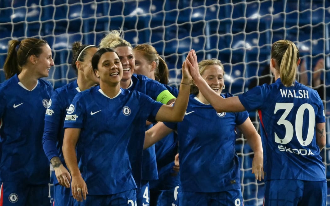 Chelsea midfielder Erin Cuthbert (C) celebrates scoring their fourth goal with striker Sam Kerr (L) and Keira Walsh (R) during the UEFA Women's Champions League match against Paris FC at Stamford Bridge in London on October 15, 2025. (Photo by JUSTIN TALLIS / AFP)