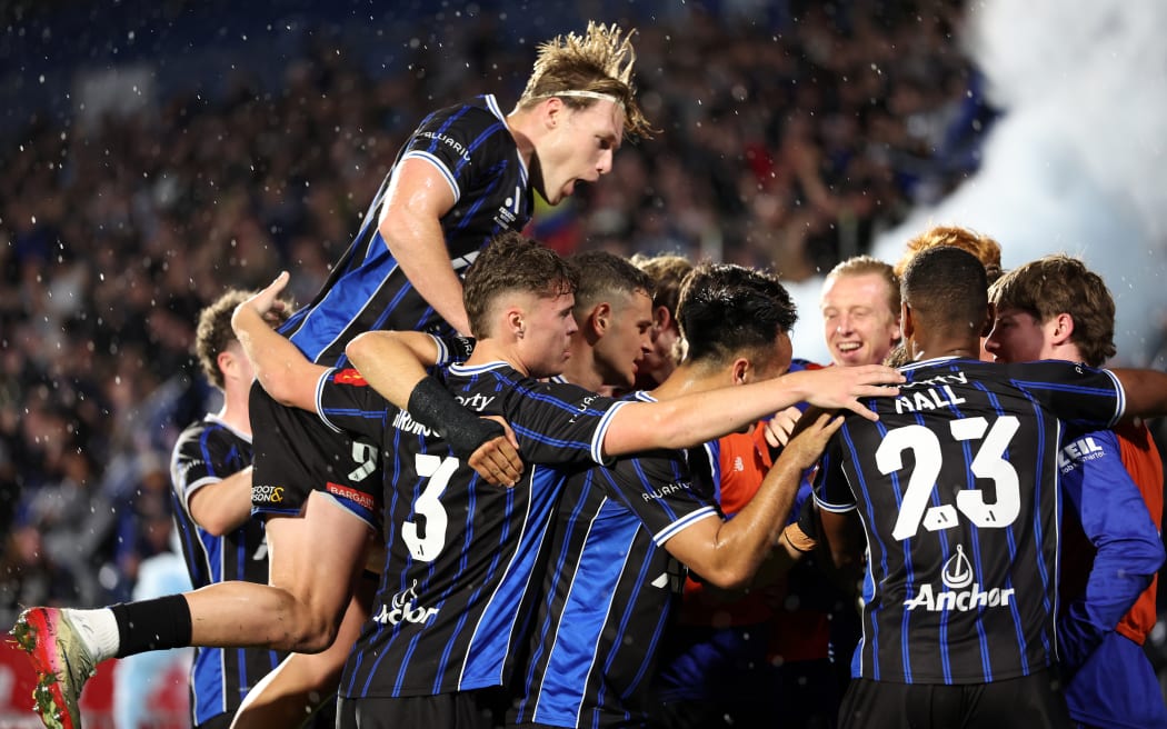 Auckland FC celebrate their first goal against Adelaide United.
