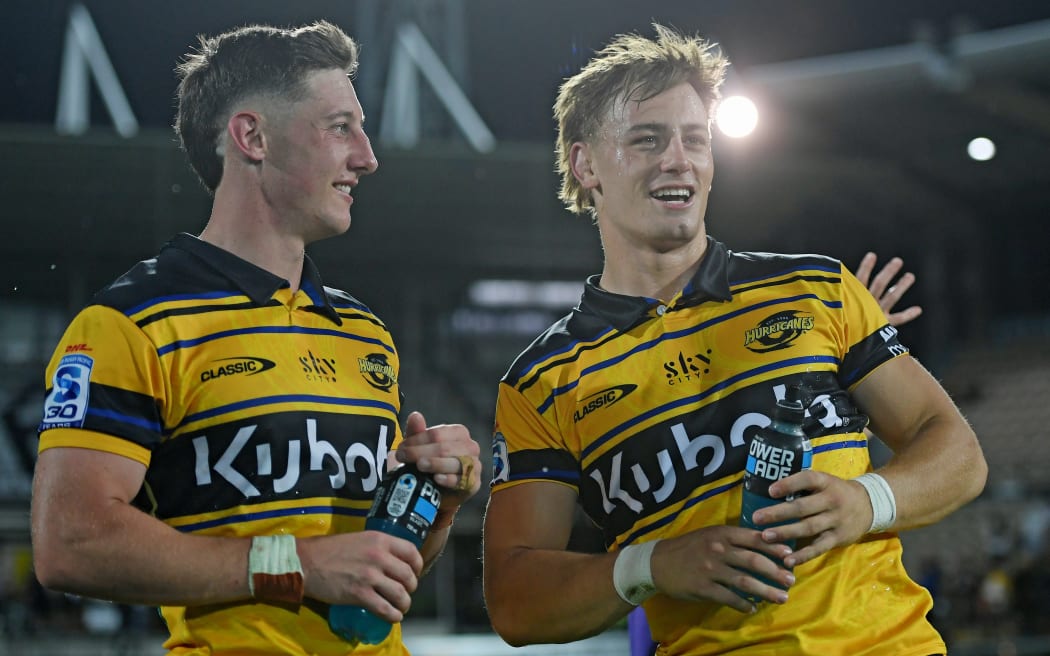 Hurricanes players Cam Roigard and Ruben Love (R).
