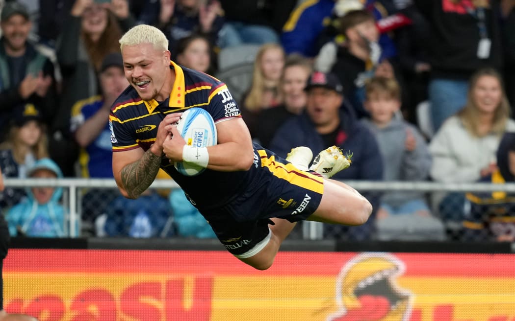Highlanders winger Caleb Tangitau scores a try.