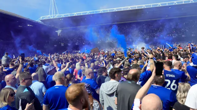 Ipswich fans celebrate on the pitch