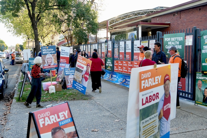 External shot of a polling booth with various corflutes visiblle.