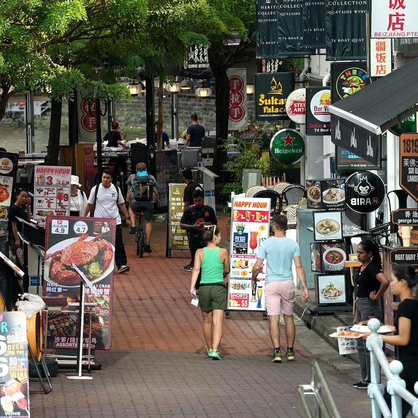 Shops line the street in Boat Quay on the Singapore River