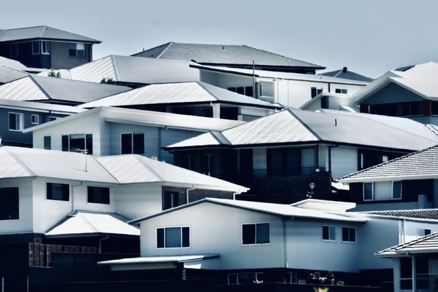 New houses sit on a hillside in a housing estate at Albion Park.