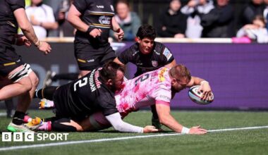 Harlequins hooker Sam Riley (number 2) is about to touch down for a try as George McGuigan (number 2) tries to stop him and Newcastle's Simon Benitez Cruz is crouched and watching