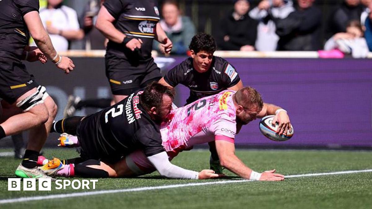 Harlequins hooker Sam Riley (number 2) is about to touch down for a try as George McGuigan (number 2) tries to stop him and Newcastle's Simon Benitez Cruz is crouched and watching