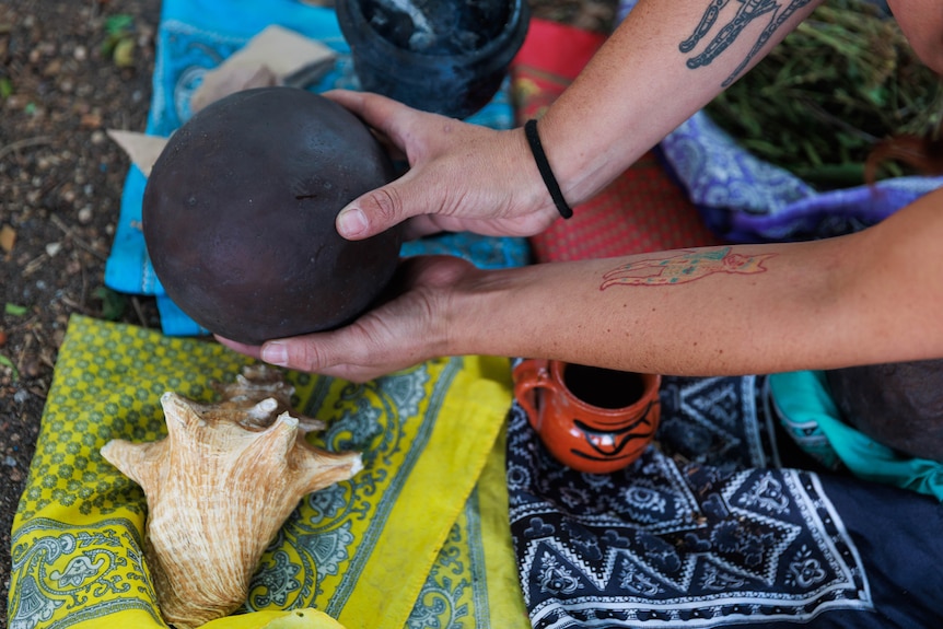 People hold a hule, an ulama ball