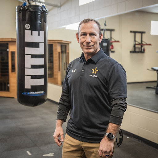 Man stands next to hanging boxing bag