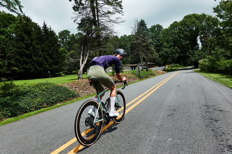Cyclist riding on a rural road Cyclist riding on a rural road