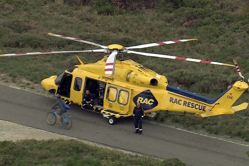 A yellow RAC rescue helicopter is on the ground