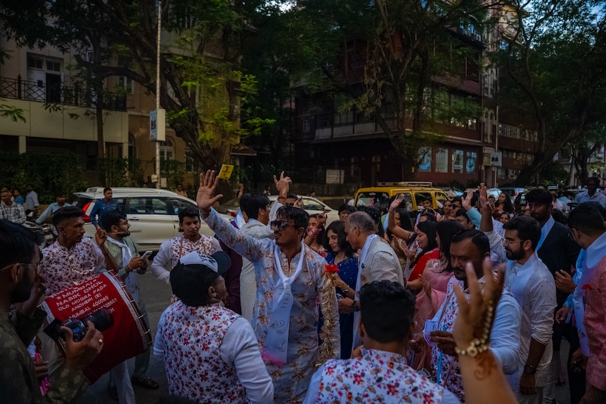 Men and women dancing and signing in the street.