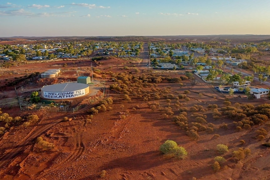 An aerial shot of a remote desert community at dusk.