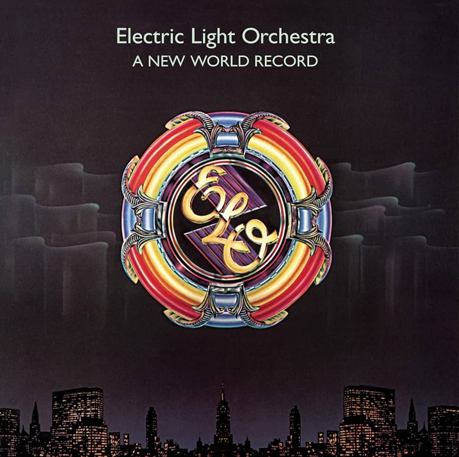 Album cover featuring the spaceship-like ELO logo over a city at night time.