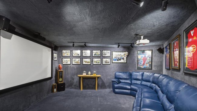 The luxury waterfront home features a cinema room filled with Gold Coast Suns and motorsport memorabilia.