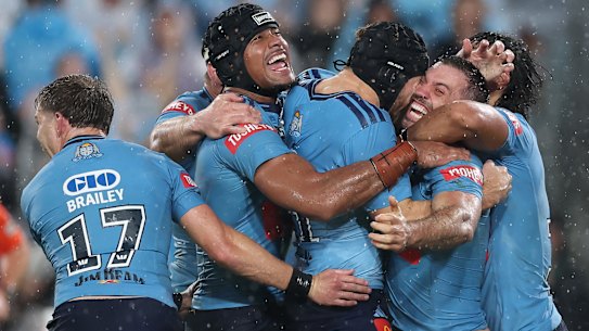 NSW players celebrate James Tedesco’s match-winning try.