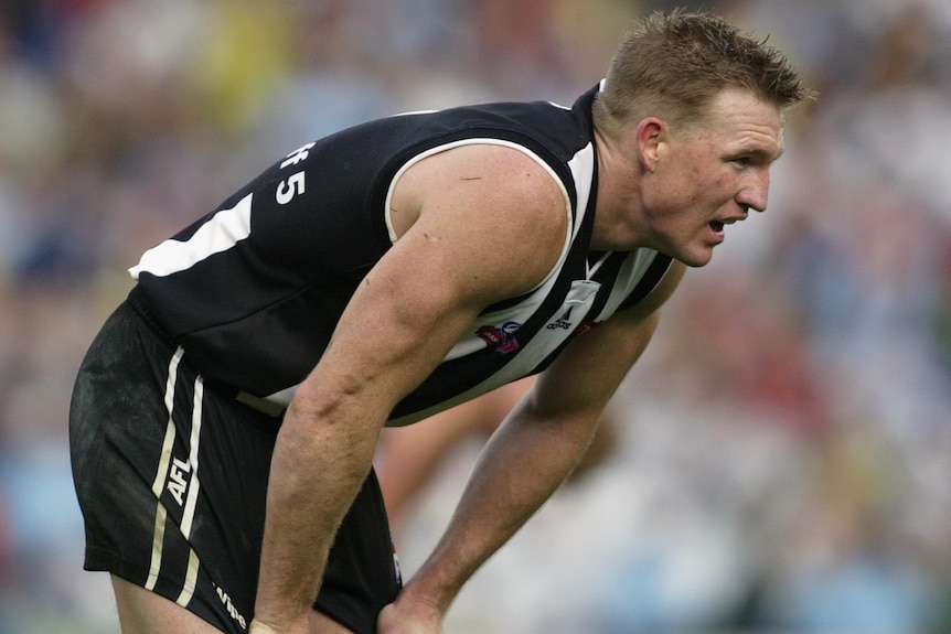 Nathan Buckley bends over and looks disappointed during the 2002 grand final