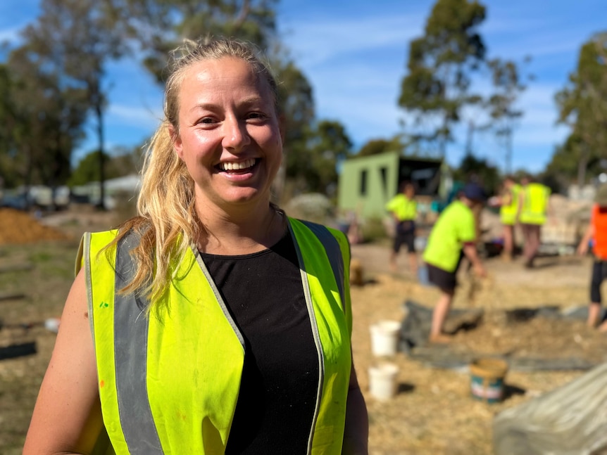 a blonde woman working smiling at the camera