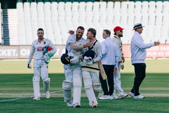 Fergus O’Neill congratulates Ollie Peake on his match-winning Sheffield Shield knock.