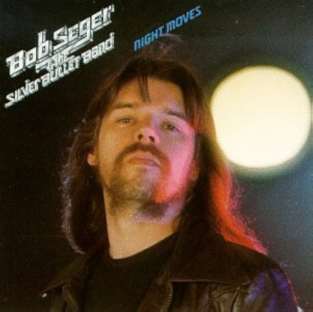 Album cover featuring a long-haired moustachioed man and a bright light behind him