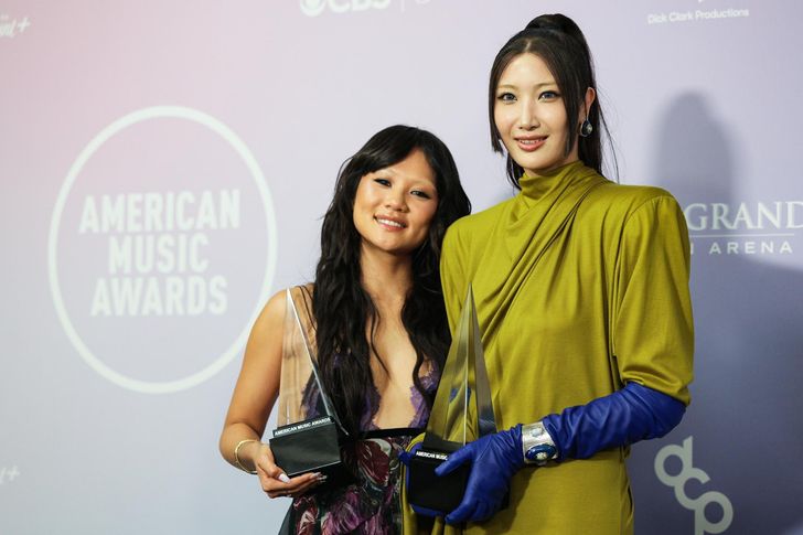 Singers Rei Ami, left, and EJAE hold the award for Song of the Year for 'Golden' in the winners' room of the American Music Awards at the MGM Grand Garden Arena in Las Vegas, Sunday (local time). EPA-Yonhap