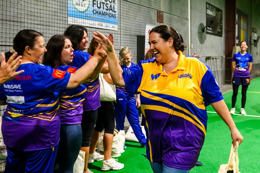 Women high-fiving each other