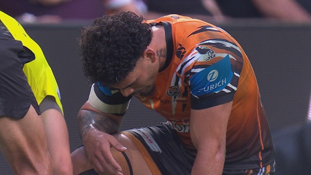 Taylan May is assisted by a trainer after suffering a shoulder injury.