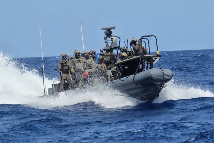 a war boat driving towards photographer