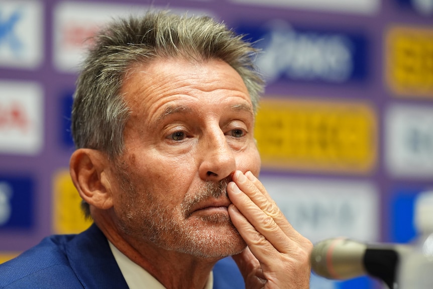Sebastian Coe holds his hand to his mouth.