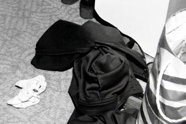 Black and white photo of some clothing on a floor