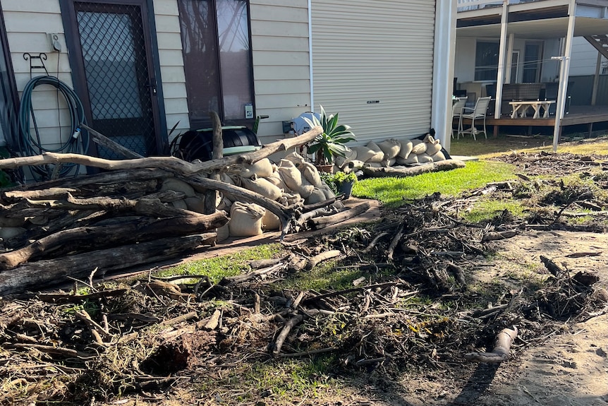storm debris at the back of a house