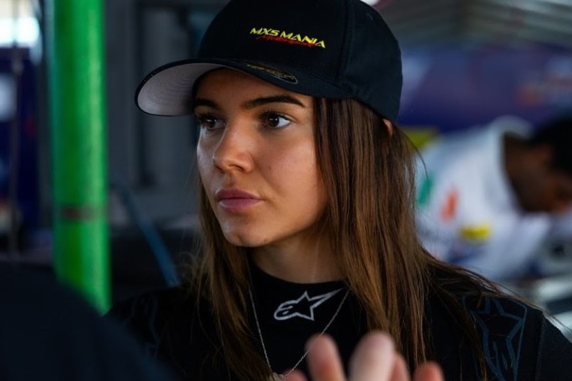 Female racing driver in the garage during a racing weekend.