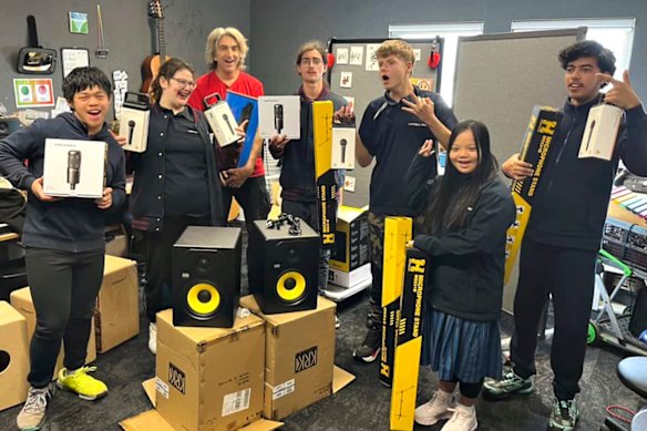Music teacher Ben Butcher (in red) with some of the equipment gifted by Snoop Dogg to Warringa Park School in Werribee South to help students record their music. 
