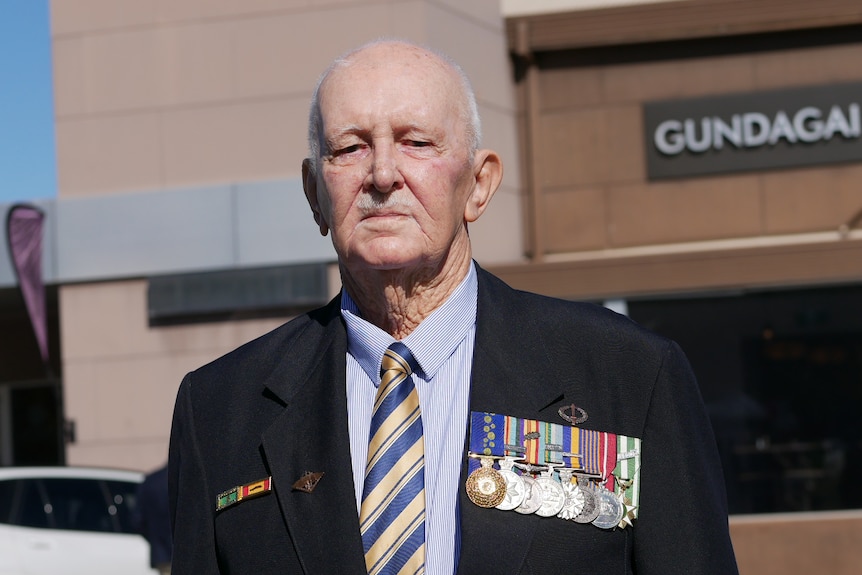 Man in a suit wearing war medals