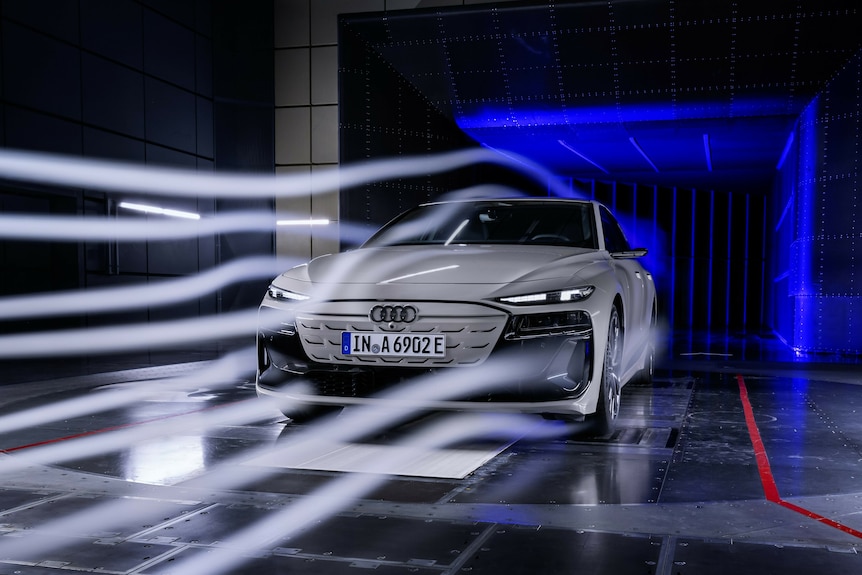 A sleek, white car in a wind tunnel.