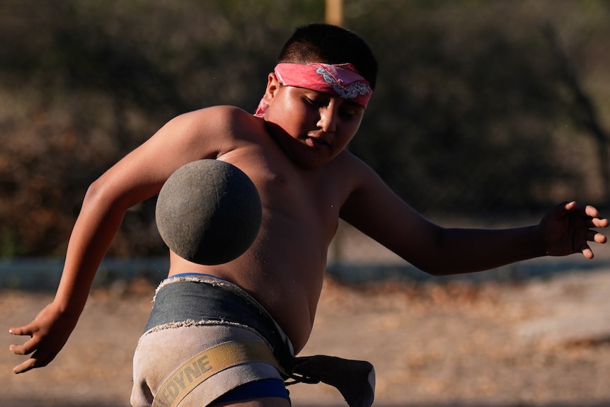 A boy plays ulama