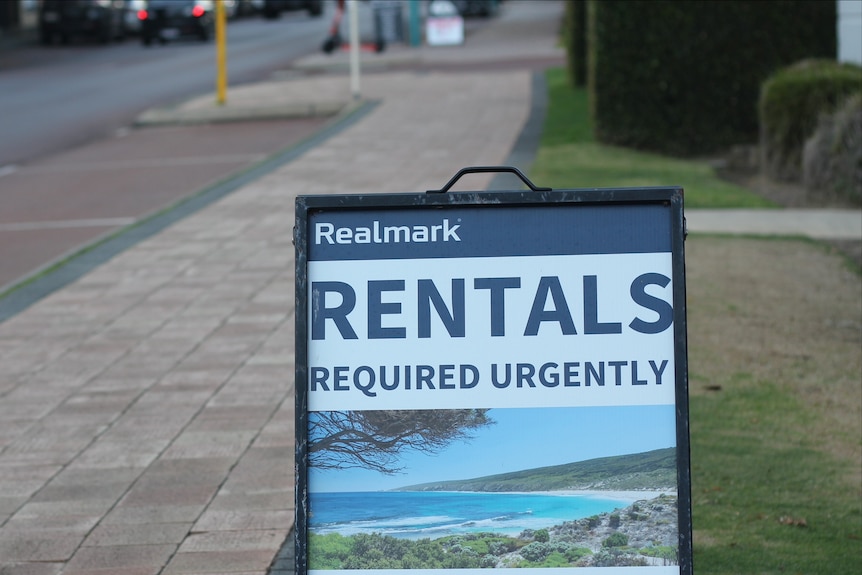 A sign near a footpath reads: rentals required urgently.