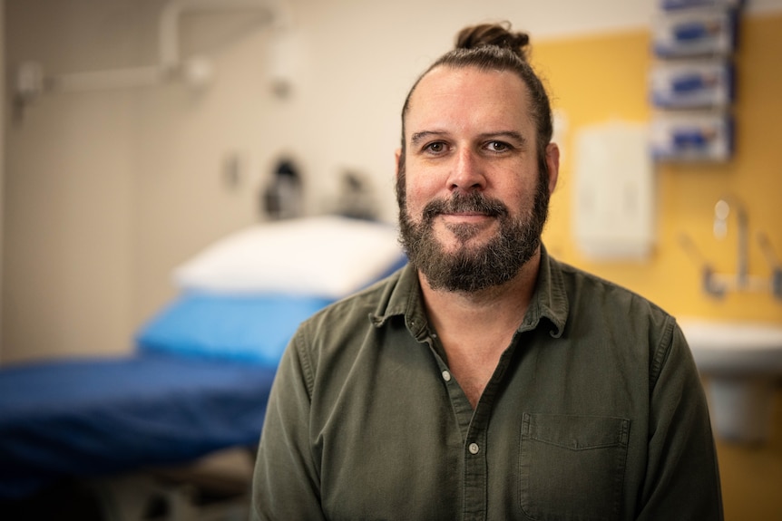 Man in collared shirt in doctor's office