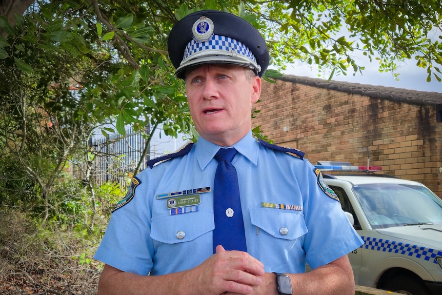 A police officer in uniform speaking.