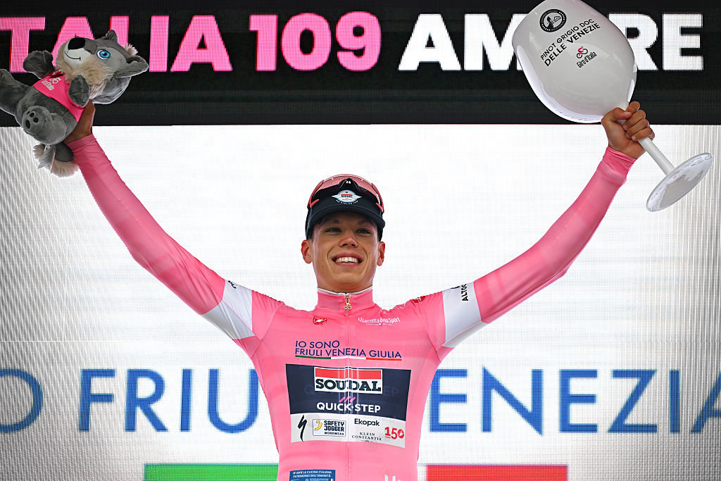 Paul Magnier of France and Team Soudal Quick-Step celebrates at podium as Pink Leader Jersey winner during the 109th Giro d'Italia