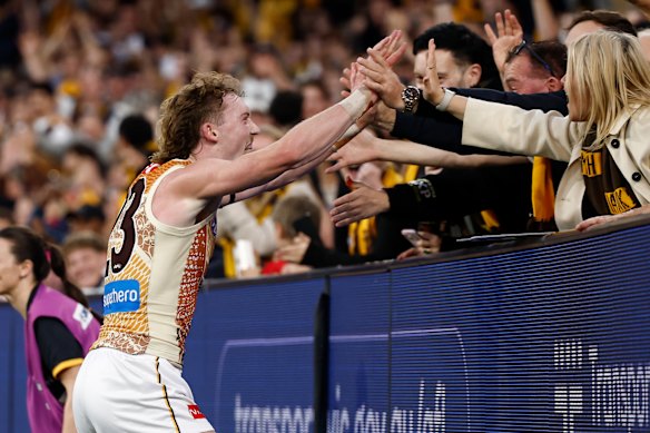 Josh Weddle of the Hawks celebrates a goal with fans.