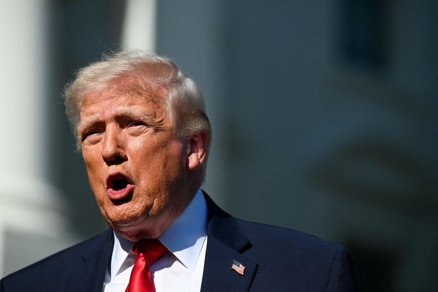 Trump squints as he faces the sun and speaks