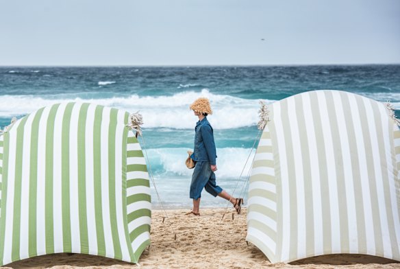 Cabanas shielded the “front row” from morning showers at Tamarama Beach for the Commas show.