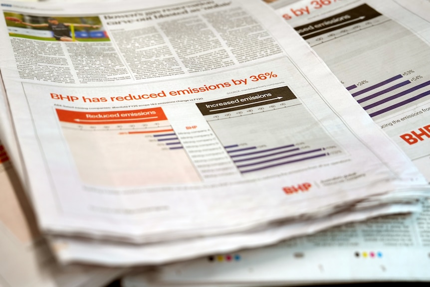 Three newspapers with the same ad which says 'BHP has reduced emissions by 36 per cent' and has graphs.