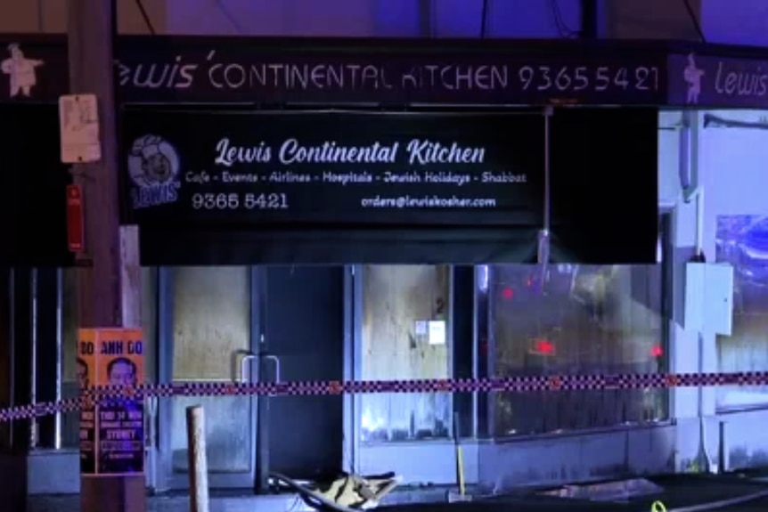 Shop building on street with police tape