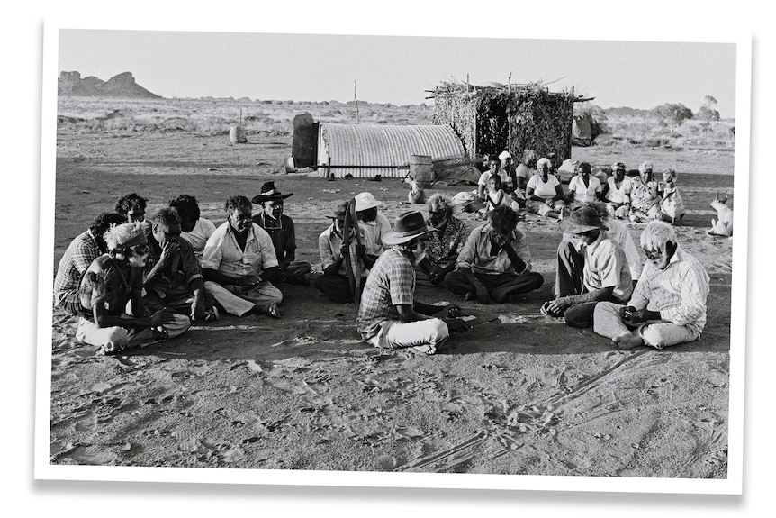 An archival image of a group of Pilbara strikers sitting in a circle.