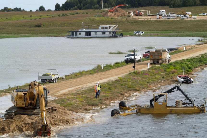 People build a earthen road into a water body