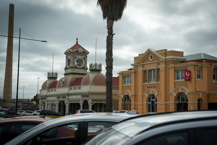 A railway station building beside a post office.