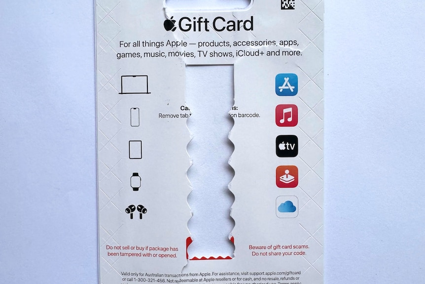 A ripped cardboard of an Apple gift card.